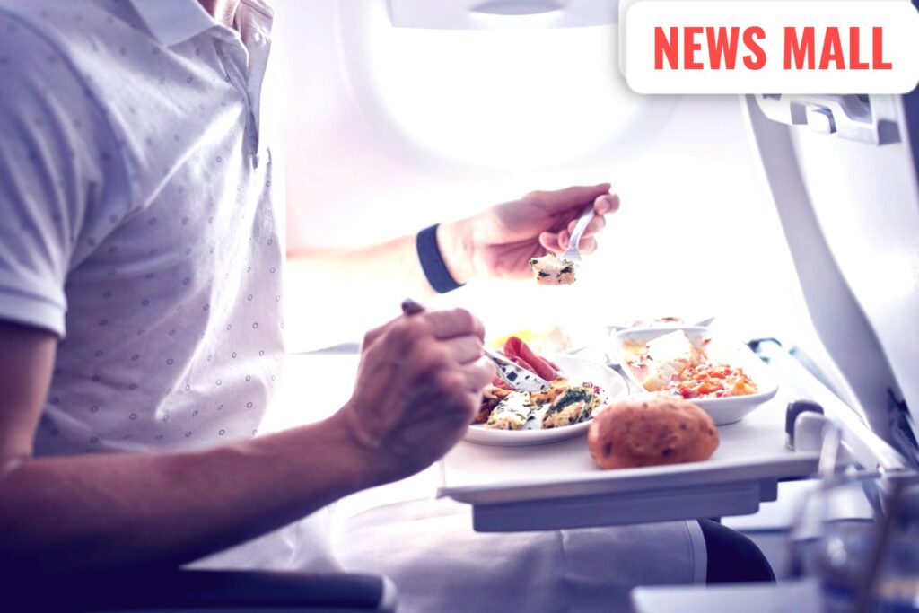 Two pilots sitting in an airplane cockpit following aviation safety and separate meal protocols.