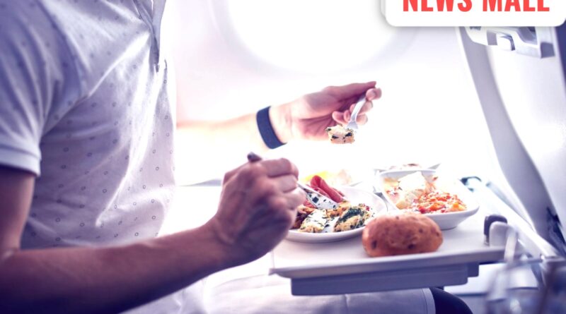 Two pilots sitting in an airplane cockpit following aviation safety and separate meal protocols.